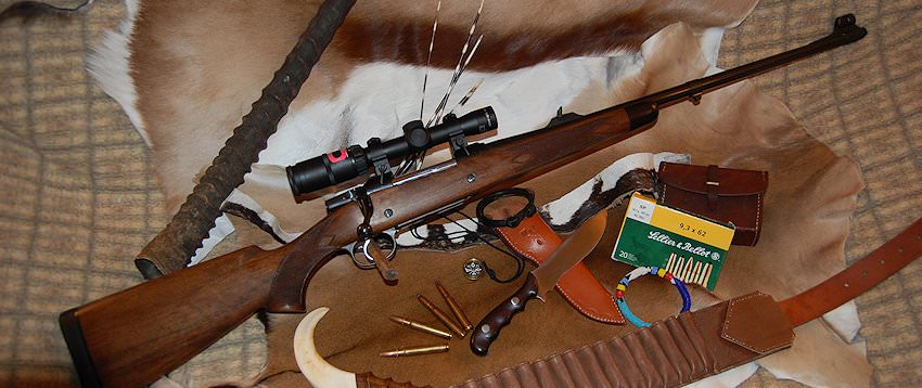 A hunter prepares to take a shot with his rifle.