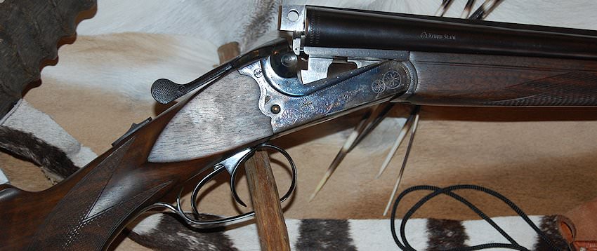 A hunter prepares to take a shot with his rifle.