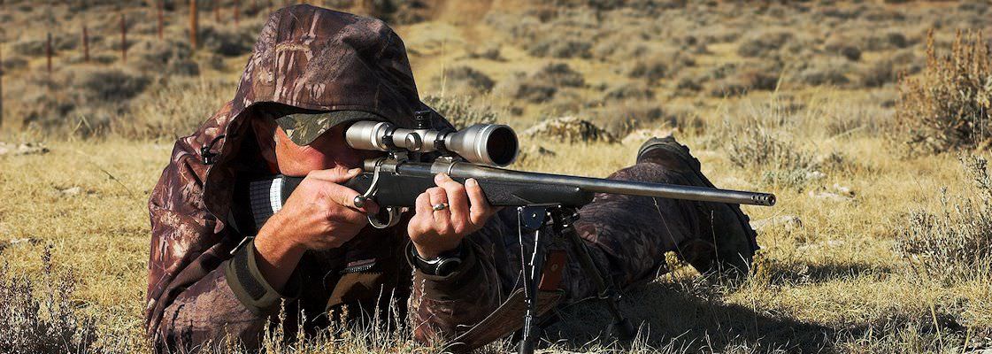 A hunter prepares to take a shot with his rifle.
