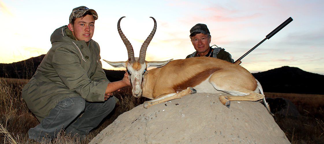 A successful father and son hunt pursuing a springbok in South Africa.