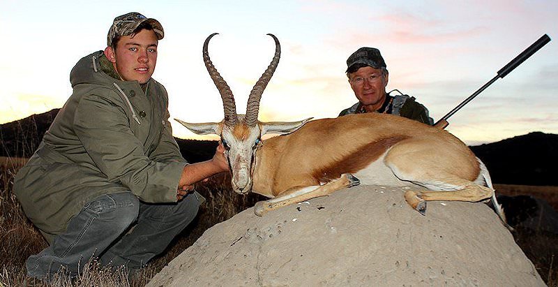 A successful father and son hunt pursuing a springbok in South Africa.