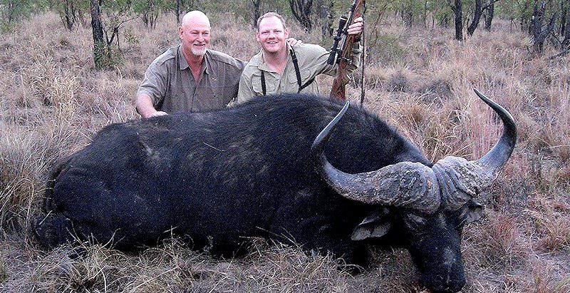 A pair of proud hunters with their Cape buffalo trophy.