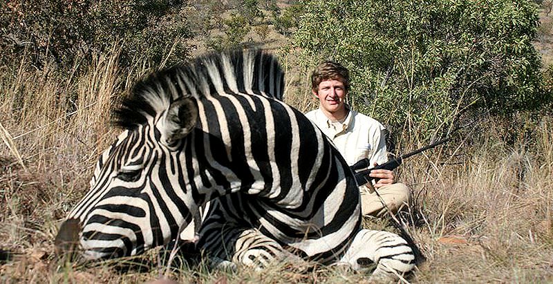 A proud hunter with his Burchell's zebra trophy.