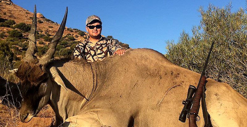 A hunter presents his immense eland trophy for a photograph.