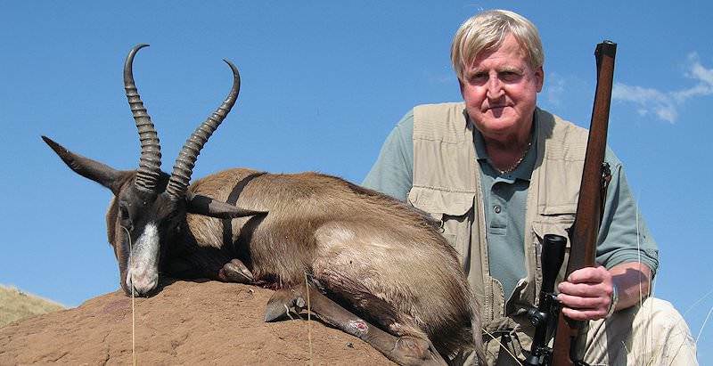 A black springbok trophy mounted atop an anthill.