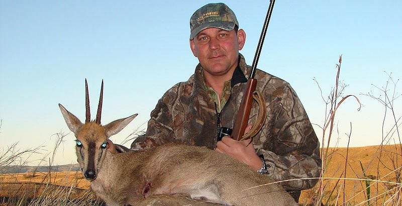 A grey duiker trophy presented for a photograph.